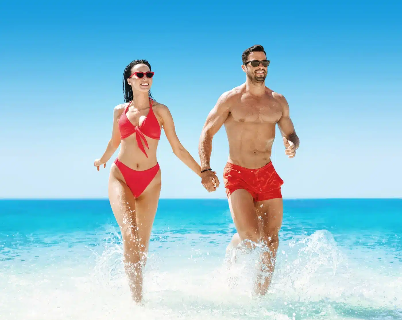 fit couple running at the beachh